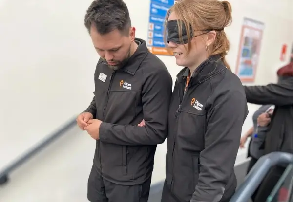 Places Leisure staff member guiding a blindfolded colleague