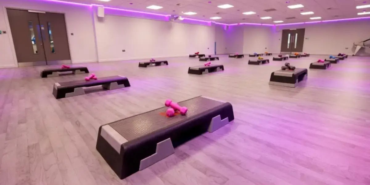 Group workout studio under pink light