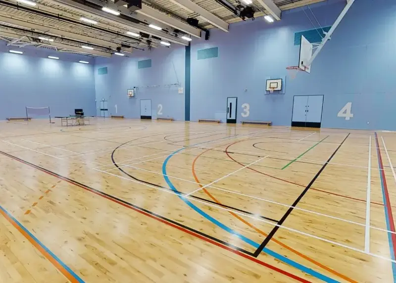 Sports hall with badminton net and table tennis table