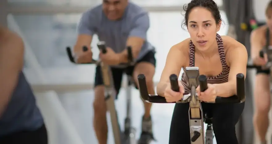 Woman on group cycling class