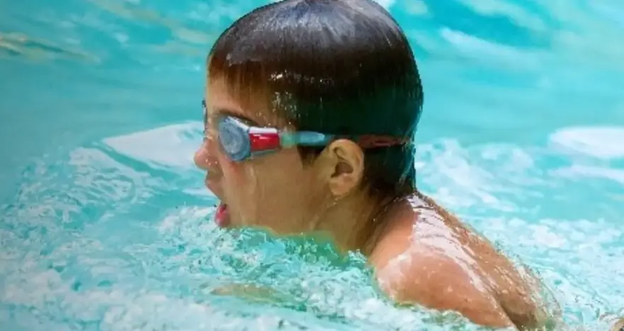 Child in googles swimming