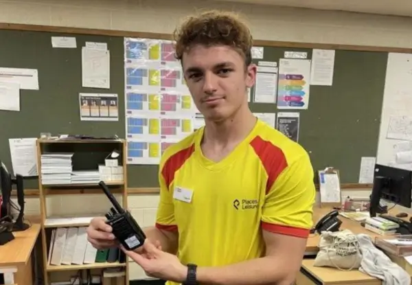 Lifeguard displaying specialist walkie talkie