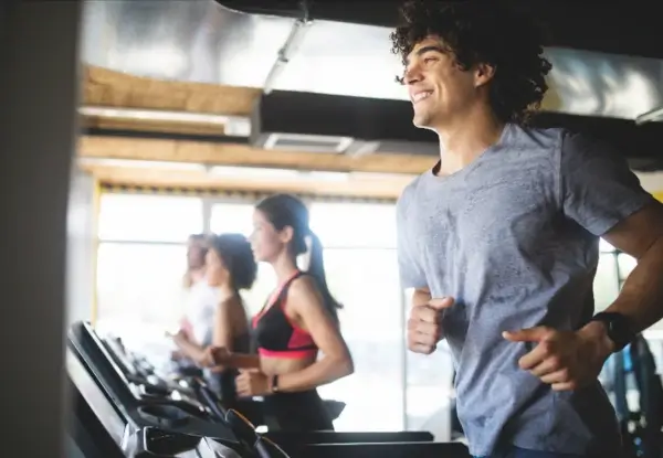 Man on treadmill with others in the background